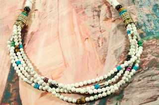 Stunning 4 Strand Necklace featuring Genuine Howlite with Genuine Turquoise, Tiger's Eye, Blue Lapis and Black Onyx Accents. Beautiful Gold fill and Sterling Silver Barrels, Beads and Clasp. Created by Navajo Artist Tommy Singer. Signed by the artist.